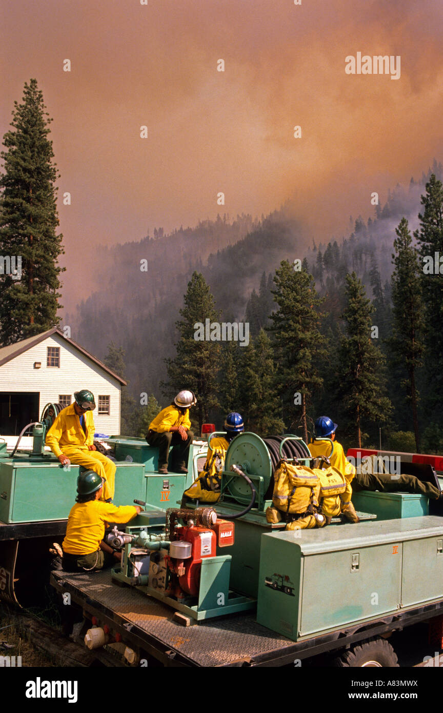 Firefighters watch a forest fire near Lowman Idaho Stock Photo