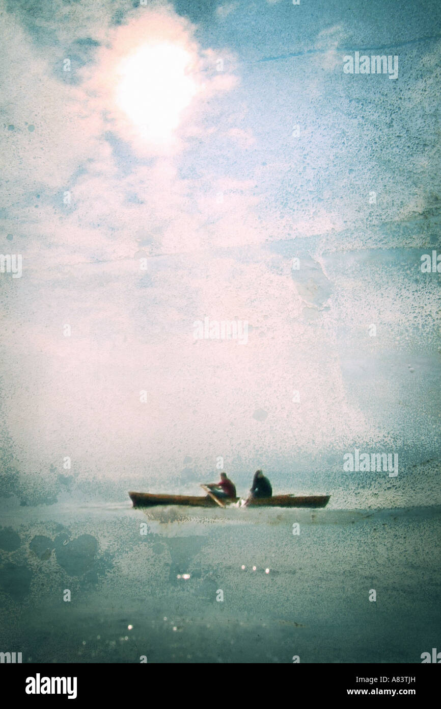 two people rowing across the sea Stock Photo