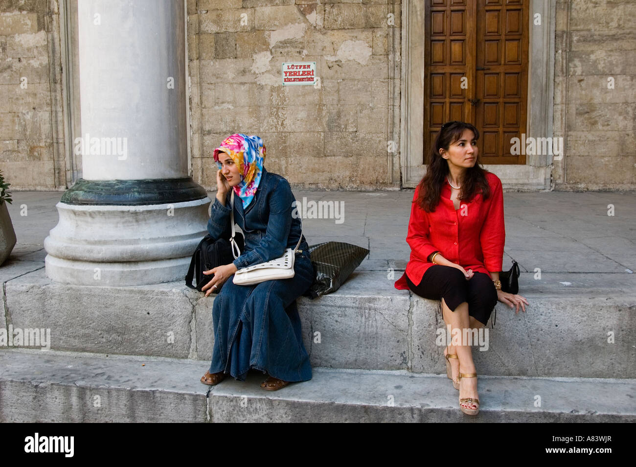 Modern versus Islamic dressed women in Yenicami mosque, Istanbul Turkey. Stock Photo