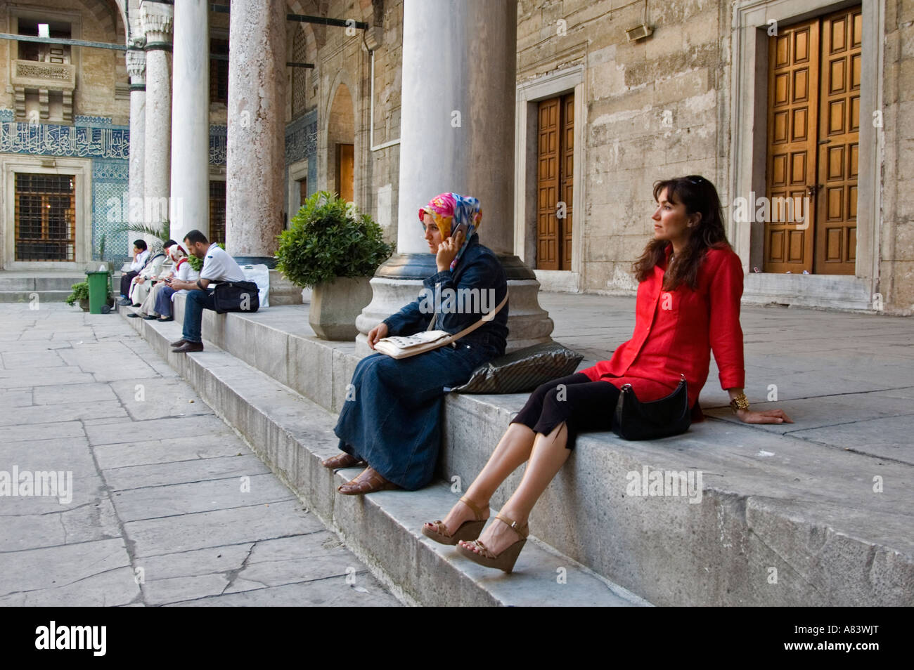 Modern versus Islamic dressed women in Yenicami mosque, Istanbul Turkey. Stock Photo