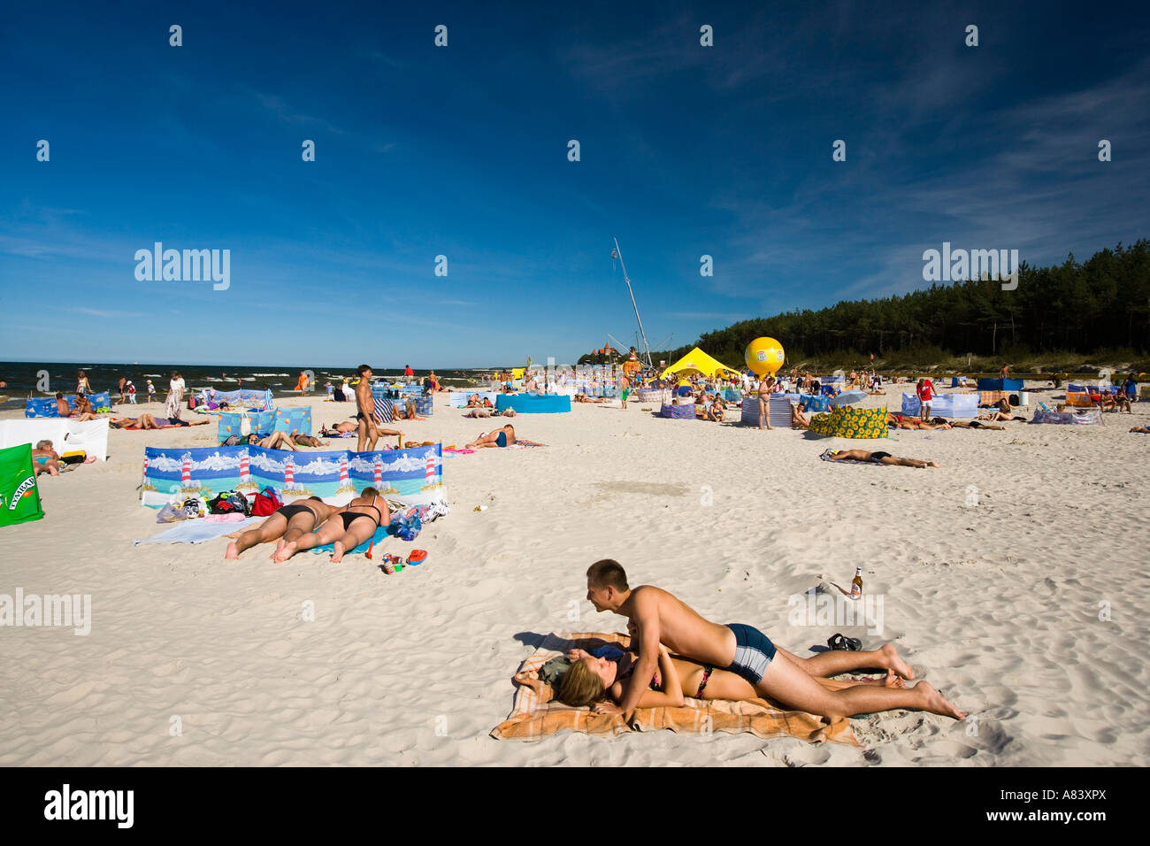 Leba Beach, Poland; a young couple pretend to have sex on the beach Stock Photo