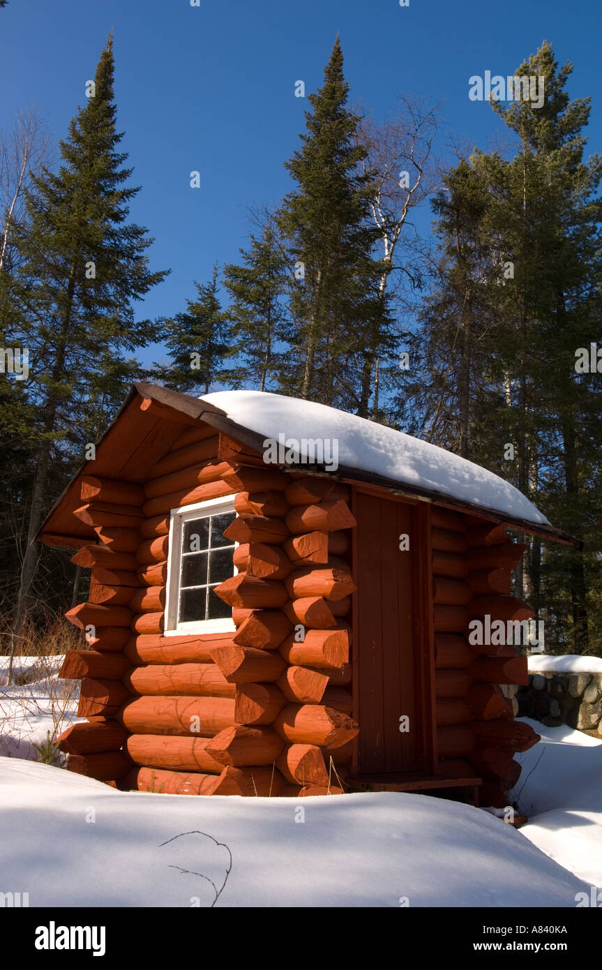 A 1930s log outhouse rescued from the BWCA Snowshoe Country Lodge Isabella Minnesota Stock Photo