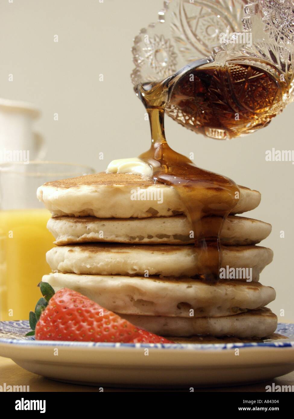 Pouring Syrup Over a Stack of Pancakes Stock Photo Alamy
