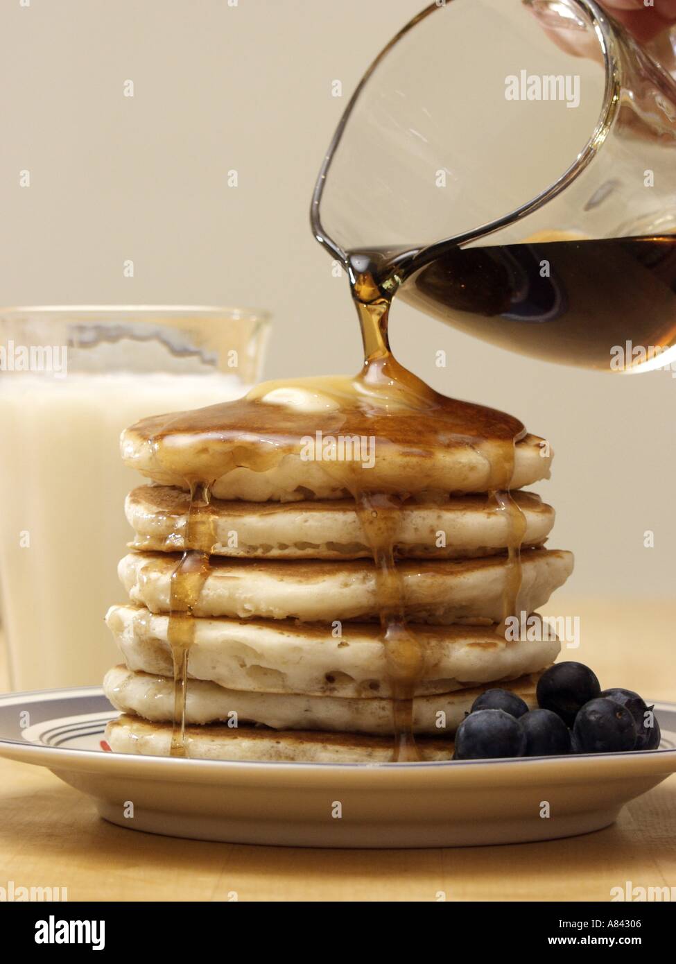 Pouring Syrup Over a Stack of Pancakes Stock Photo Alamy