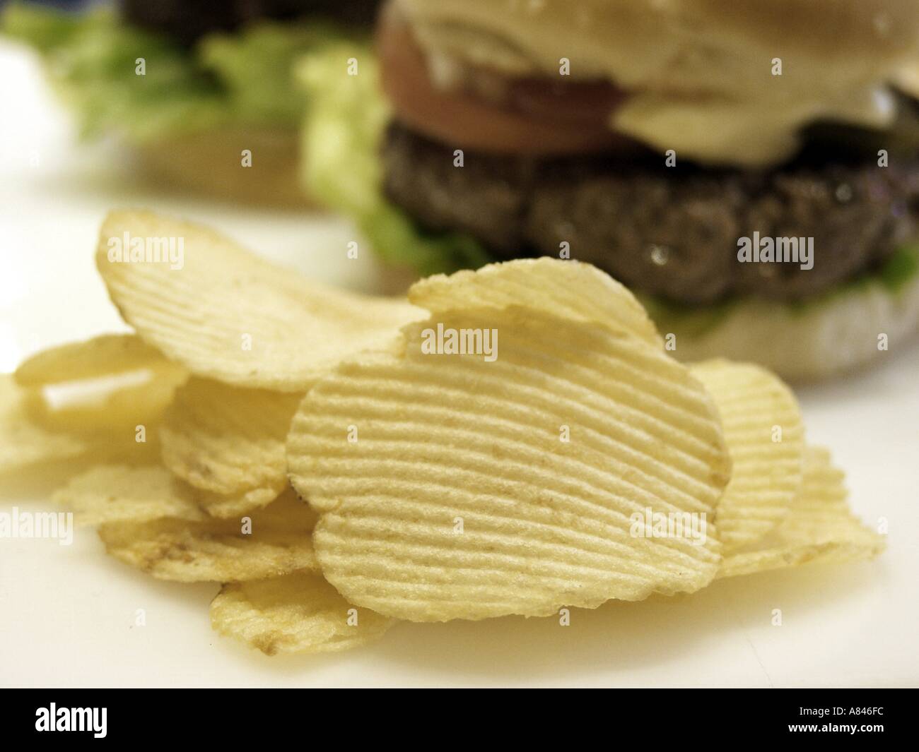 Potato Chips with Hamburger in the Background Stock Photo Alamy