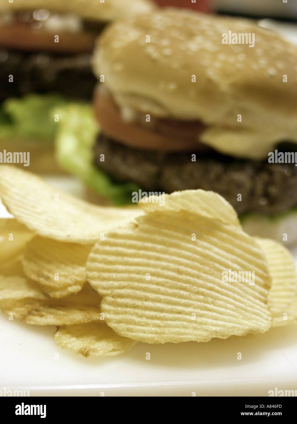 Potato Chips with Hamburger in the Background Stock Photo Alamy