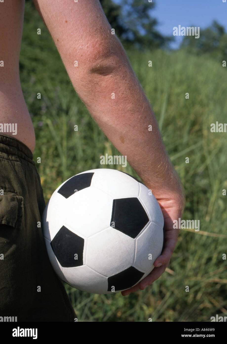 young man carrying football Stock Photo Alamy