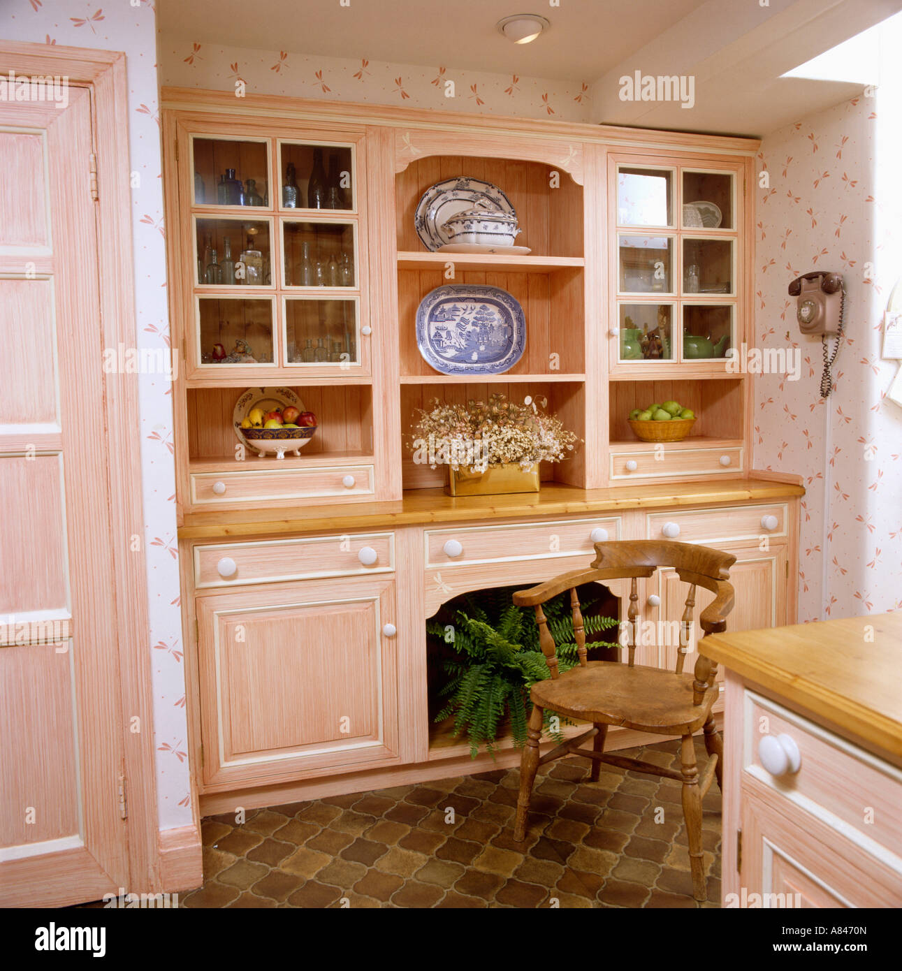 Wooden Chair In Front Of Built In Dresser In Peach Traditional