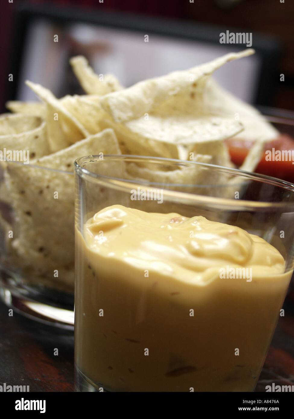 Tortilla Chips with Cheese Dip Stock Photo Alamy