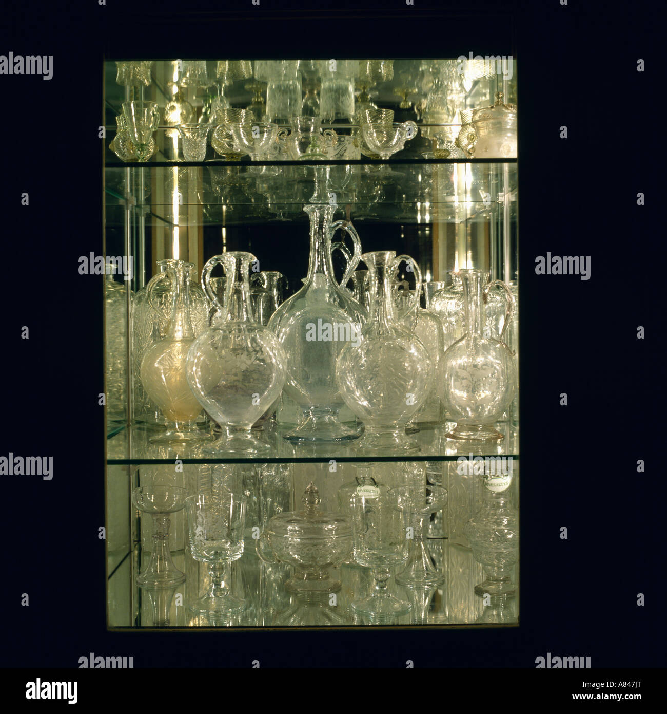 Collection of antique glass decanters on glass shelves Stock Photo