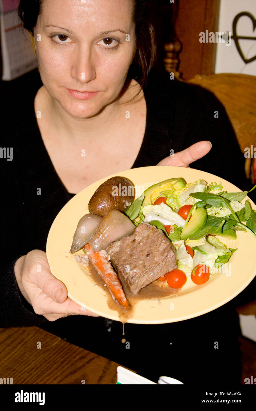 Woman age 39 displaying her roast beef dinner with all the trimmings