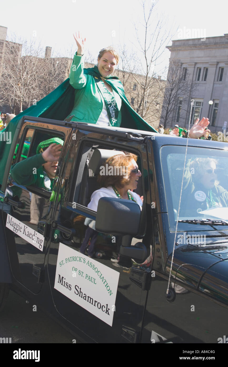 Miss Shamrock age 18 riding in SUV float waving. St Patrick's Day Parade St Paul Minnesota USA Stock Photo