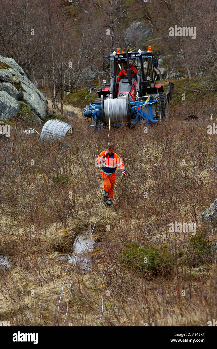 Worker changing the top wire on electric power transmission