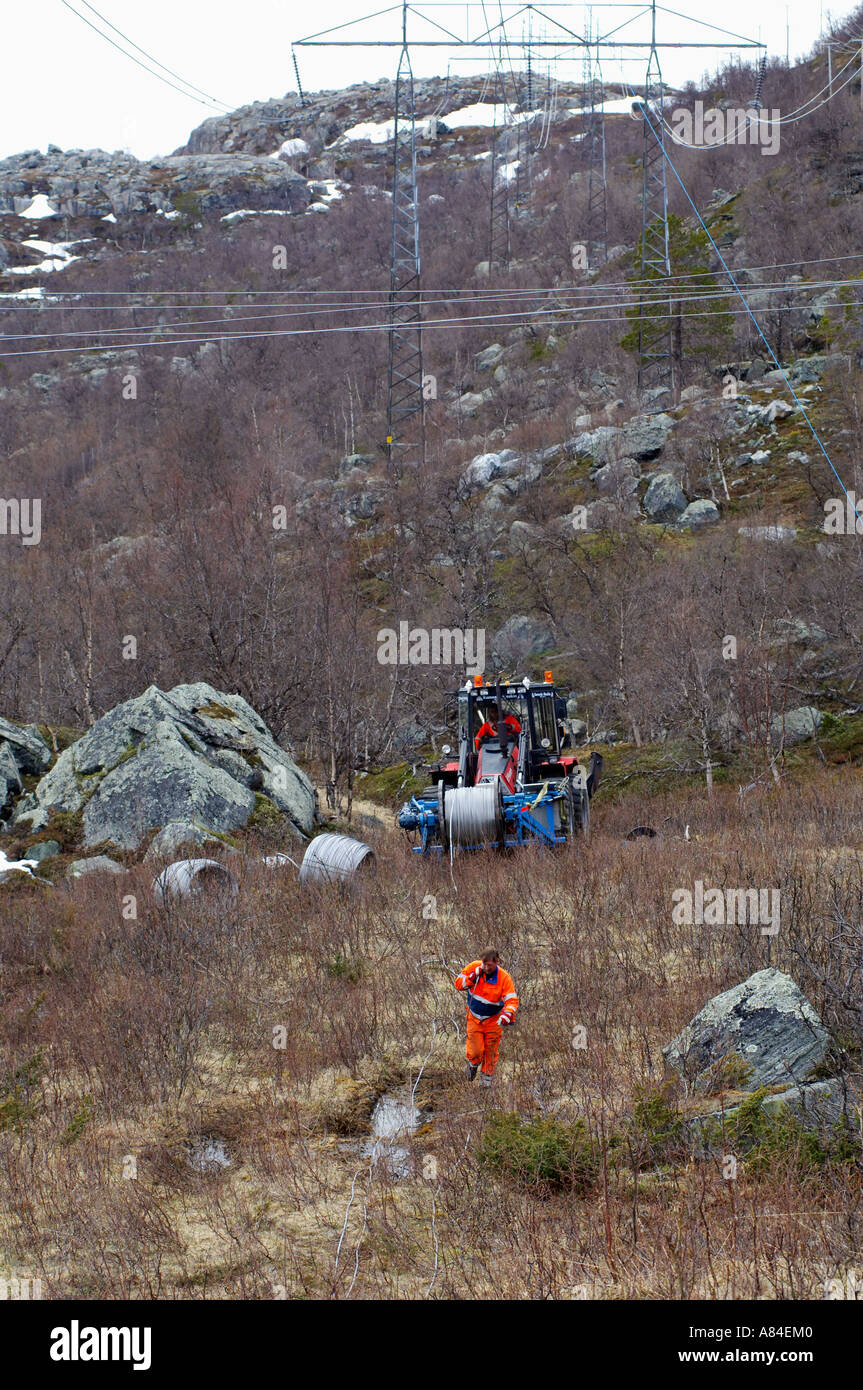 Worker changing the top wire on electric power transmission
