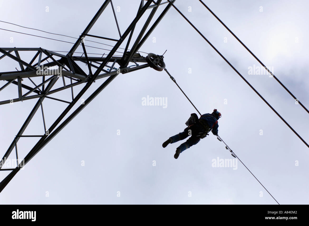 Worker changing the top wire on electric power transmission