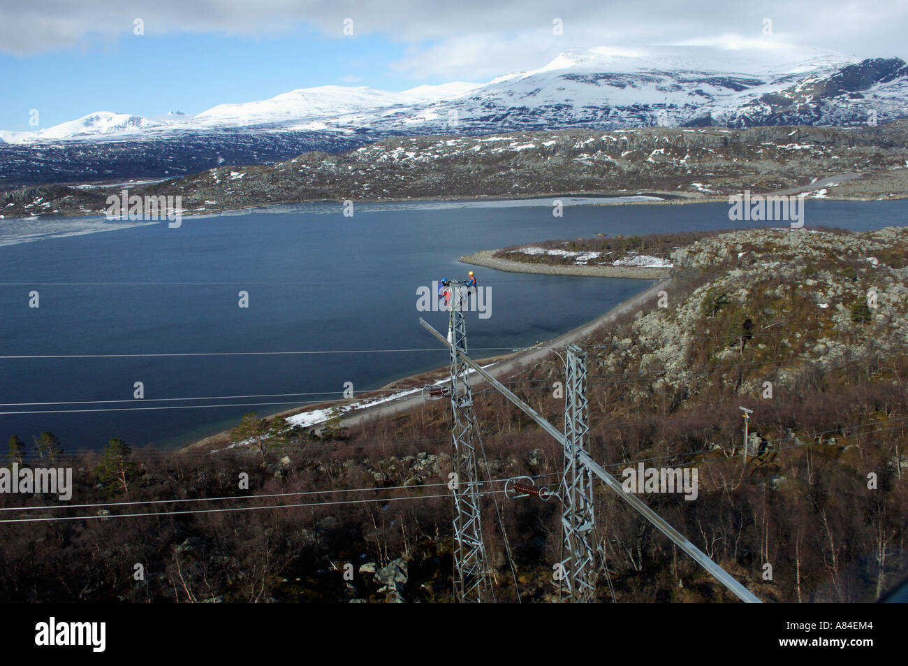 Workers changing to top wire of the power-lines running from Ritsem to Porjus in Lapland in north Sweden Stock Photo