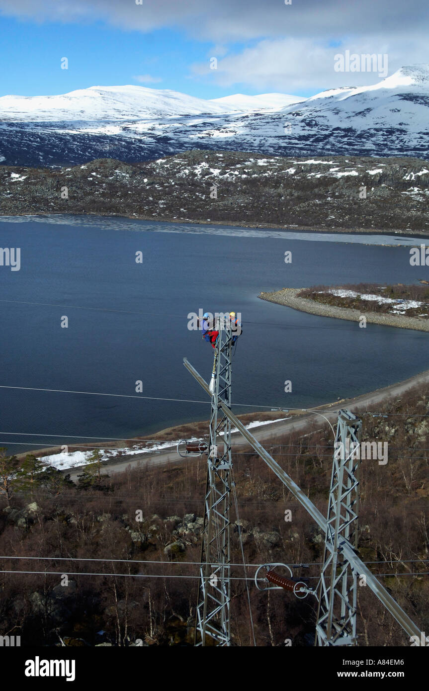 Workers changing the top wire on electric power transmission
