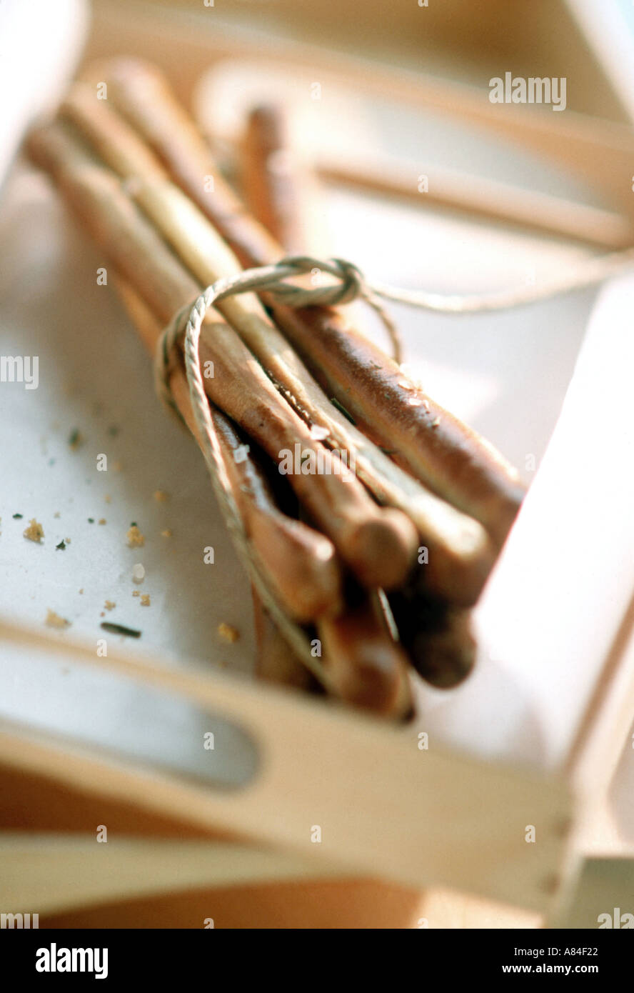 A bundle of homemade beadsticks on white and wooden tray tied up with ...