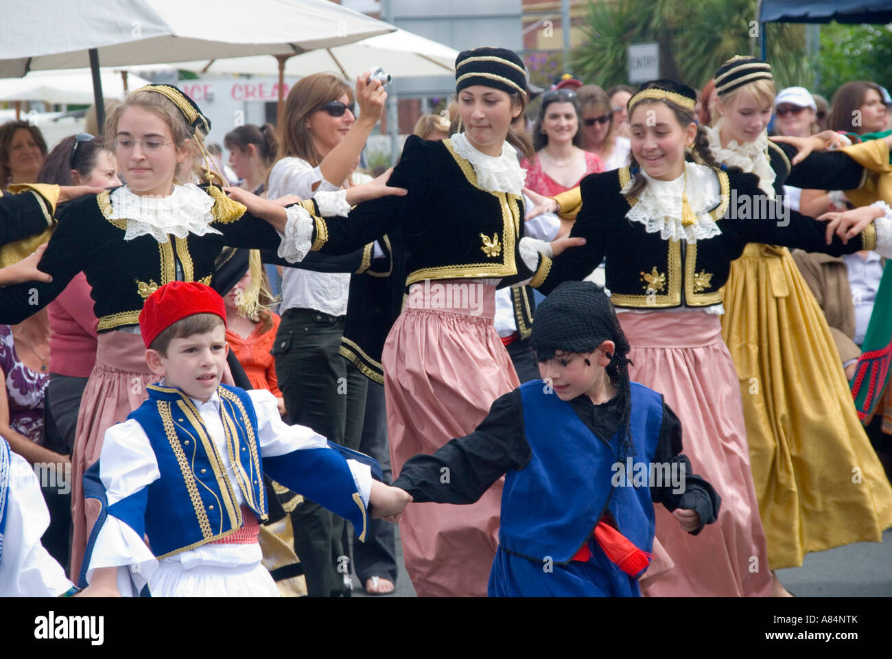 Australians of Greek descent celebrate at a festival with dancing in traditional costume Stock Photo