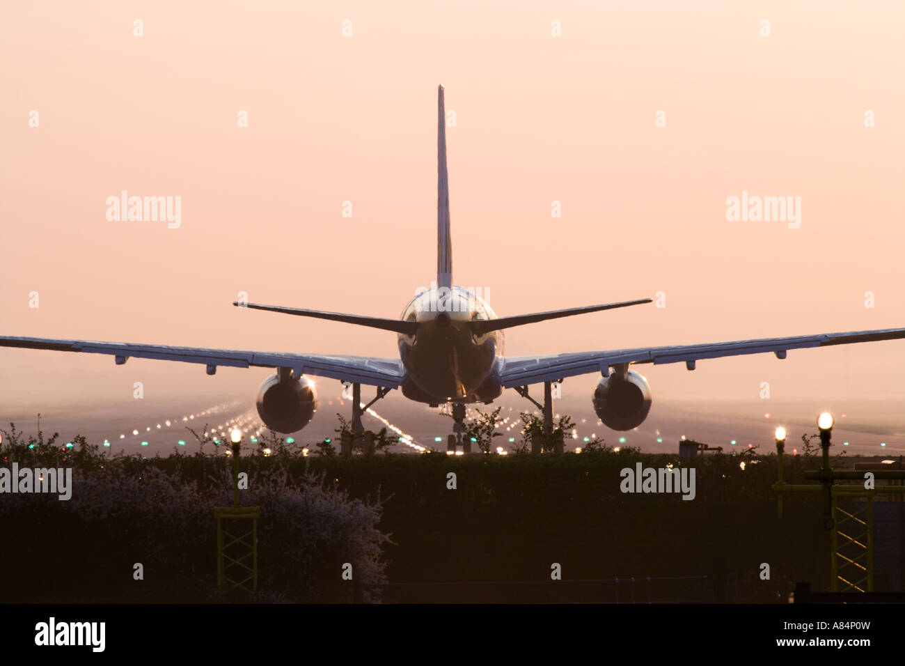 Aeroplane awaiting takeoff on runway Stock Photo