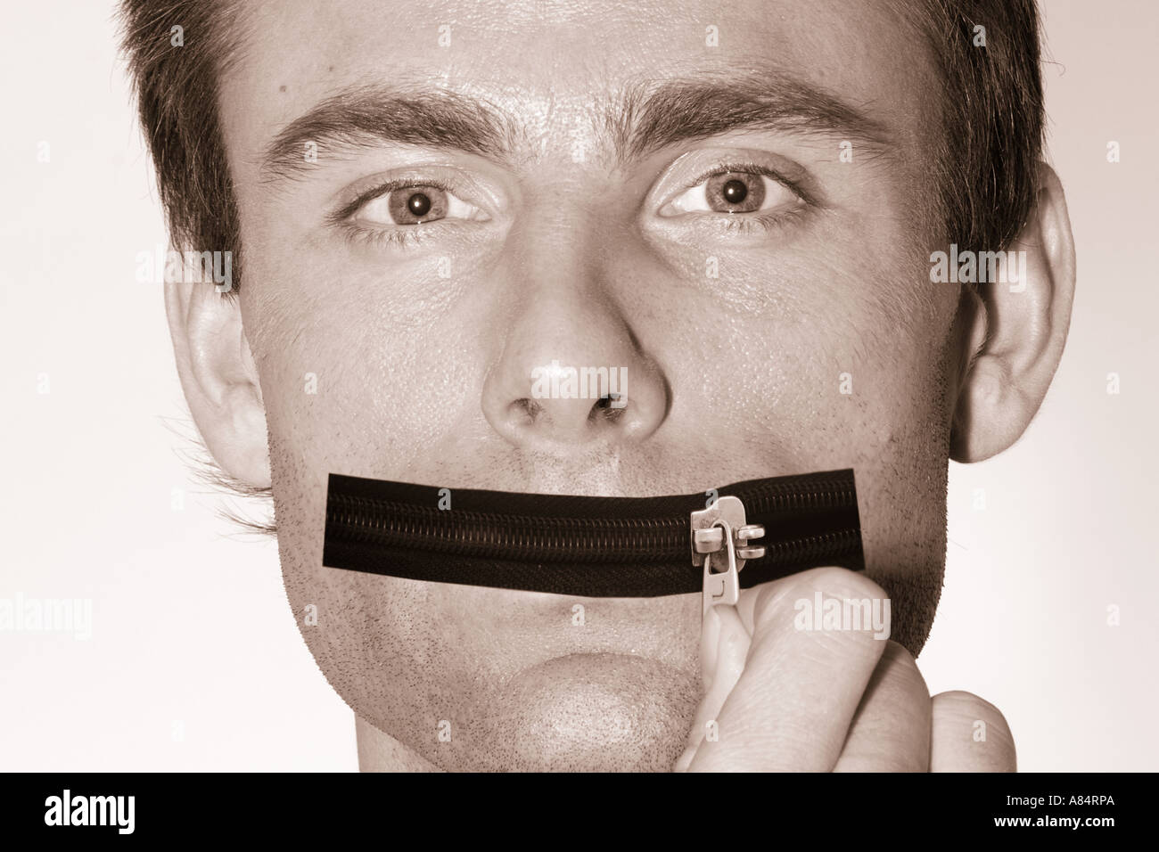 man with a zip as a mouth zip it keep a secret shut your mouth Stock Photo