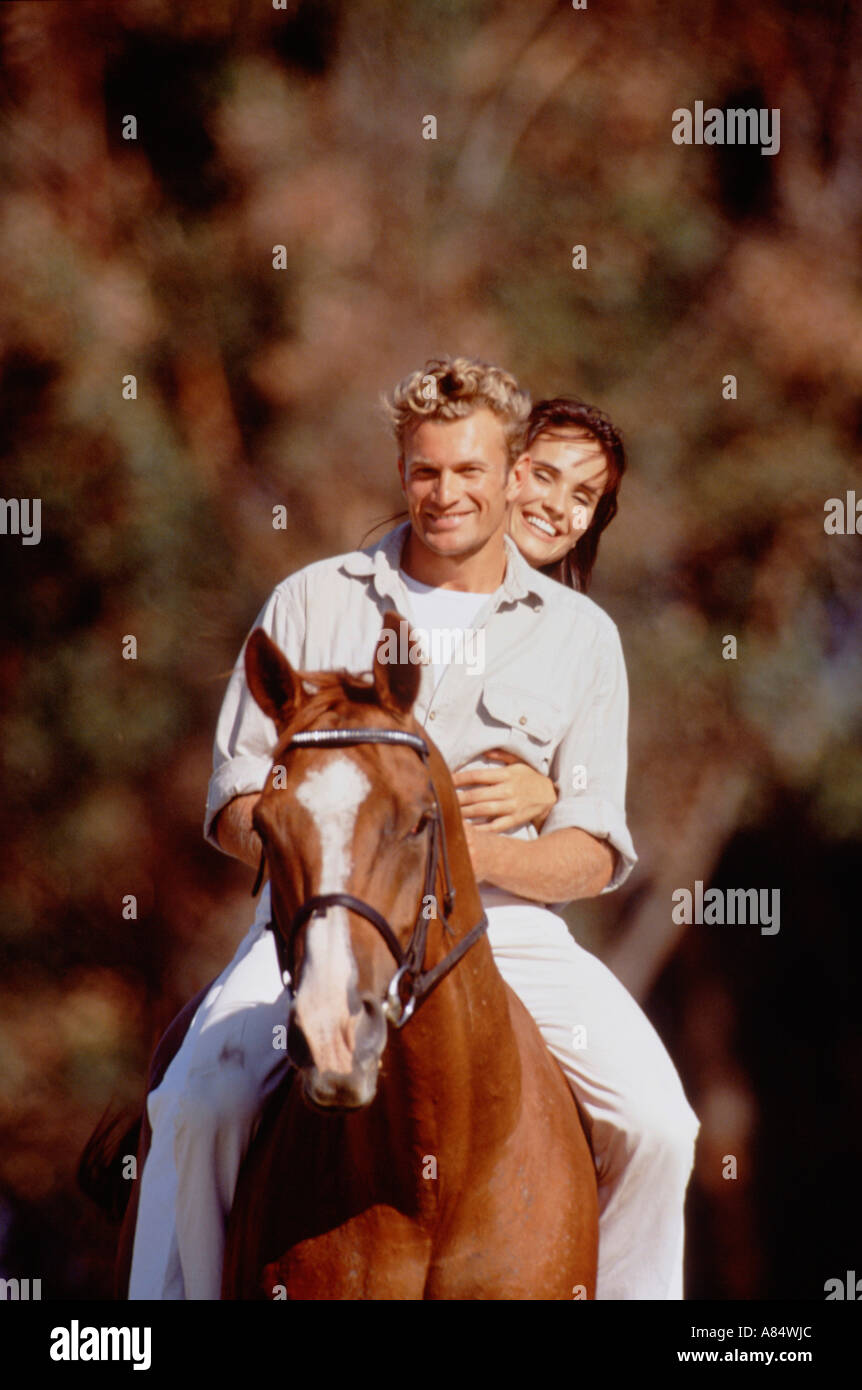 Young couple horse riding. Outdoor lifestyle Stock Photo - Alamy
