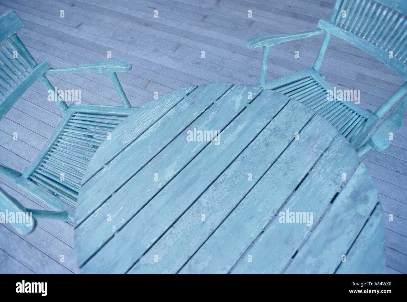 Still Life Of Painted Garden Table And Chairs On Decking Stock