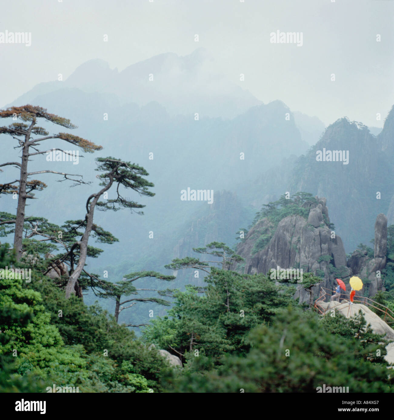 China. Huangshan mountains. Local people with Umbrellas. Stock Photo