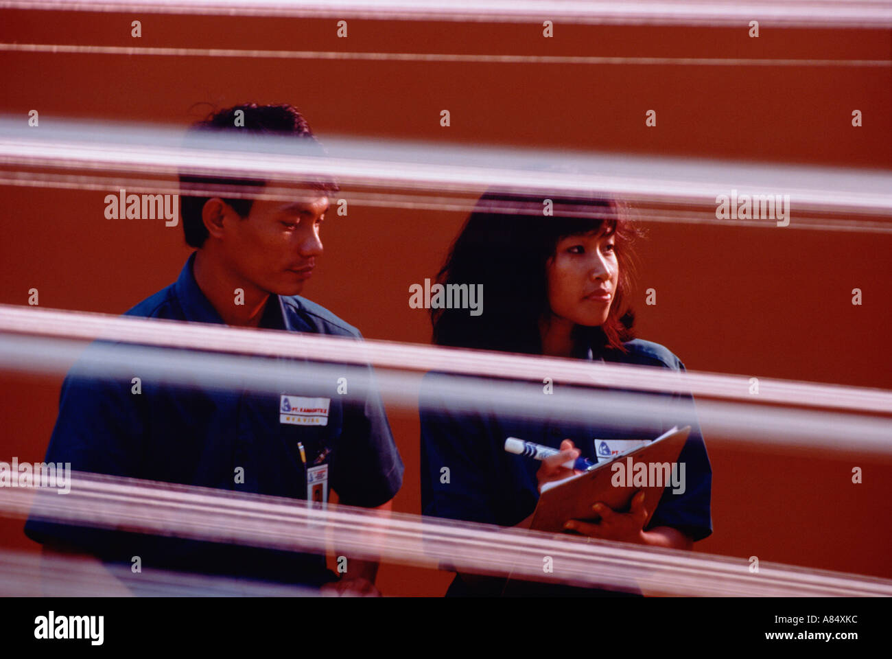 Indonesia. Man and woman industrial workers in towel factory. Stock Photo