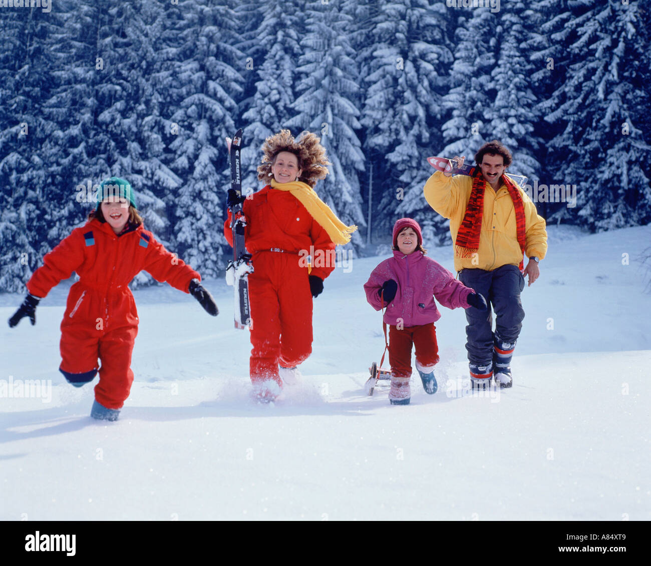 Family in snow covered landscape. Winter sports holiday. Stock Photo