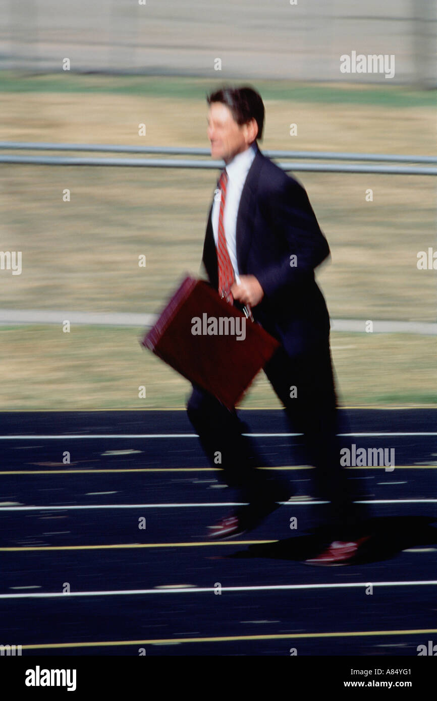 Concept image. Businessman running on athletics track. Stock Photo
