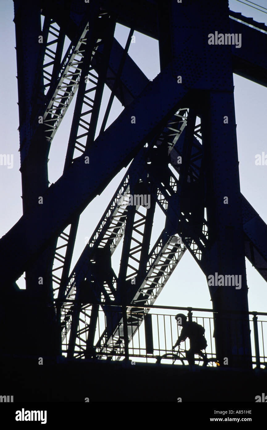 Australia. Queensland. Brisbane. Silhouette of lone cyclist on the Story Bridge. Stock Photo