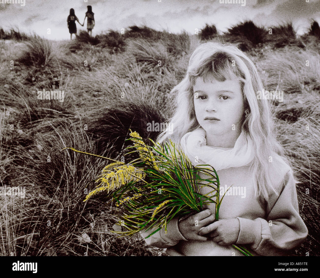 Children. Girl outdoors with wild flowers bunch. Australia. Stock Photo