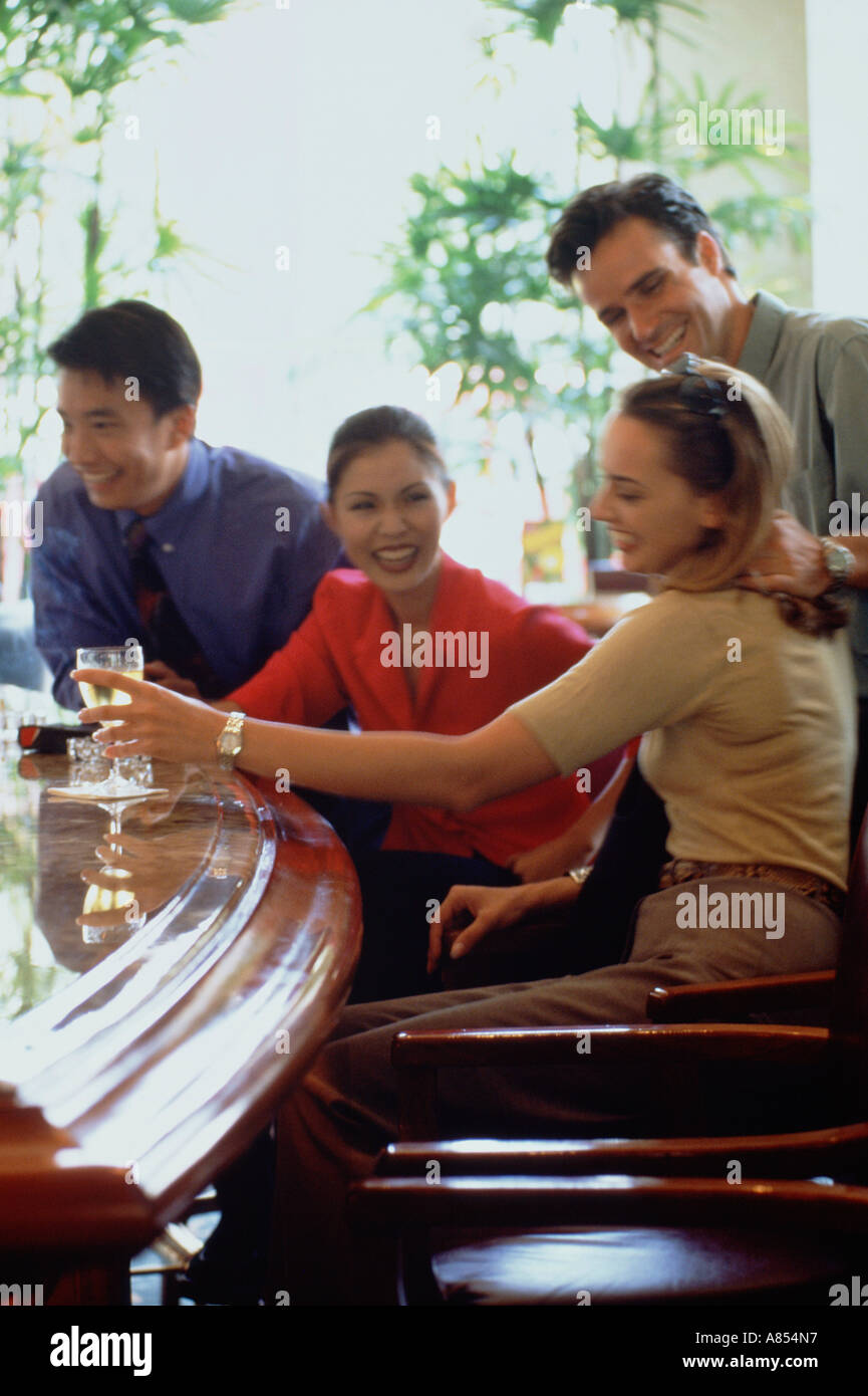 Two happy couples drinking at a bar. Stock Photo