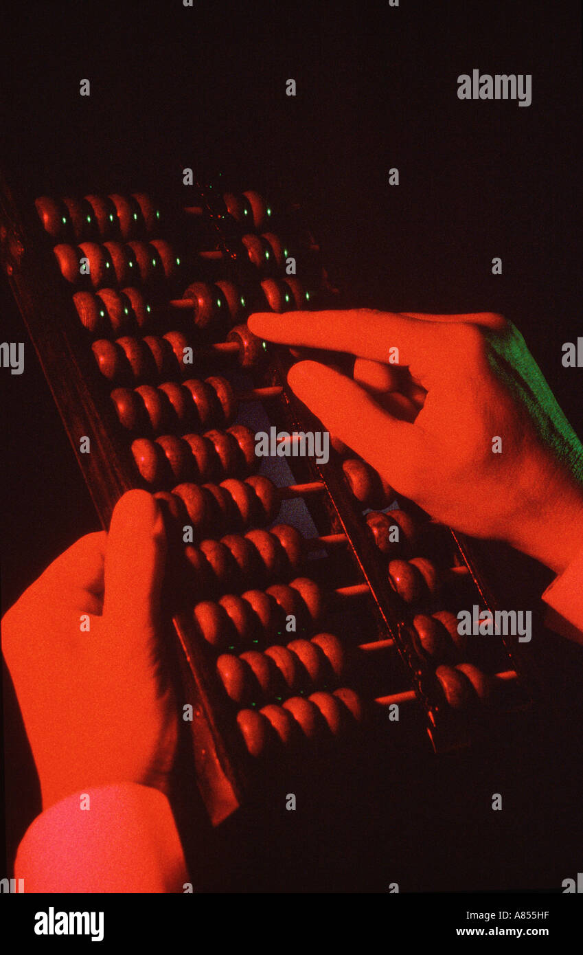Close-up of man's hands using an abacus. Stock Photo