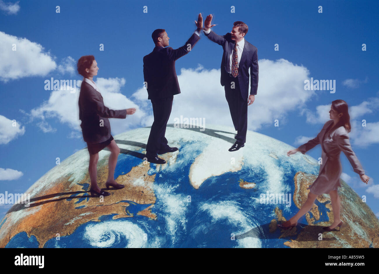International business concept of four people on top of the world. Stock Photo