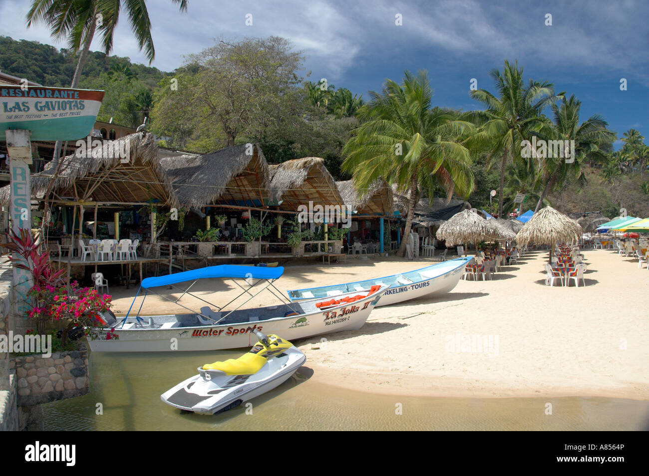 Mismaloya Beach with colorful boats and thatched shelters south of Puerto Vallarta Mexico Stock Photo