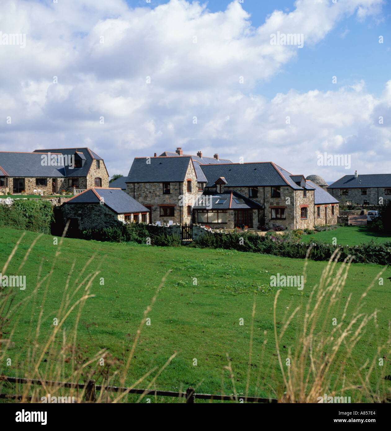 Completed conversion of old farm buildings into modern housing, near