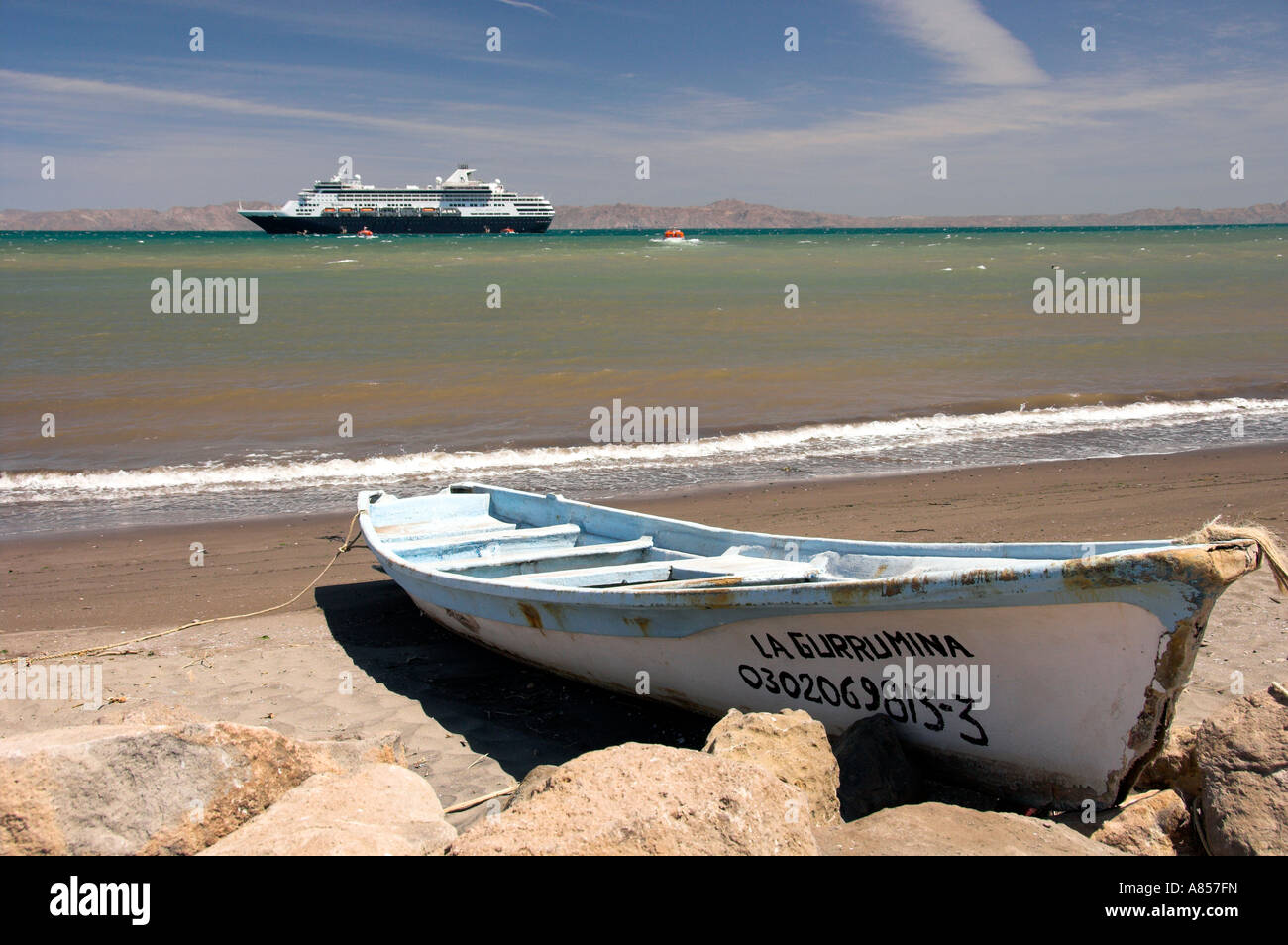 Colorful fishing boats with a cruise ship and the Baja Sur port of Loreto Mexico Stock Photo