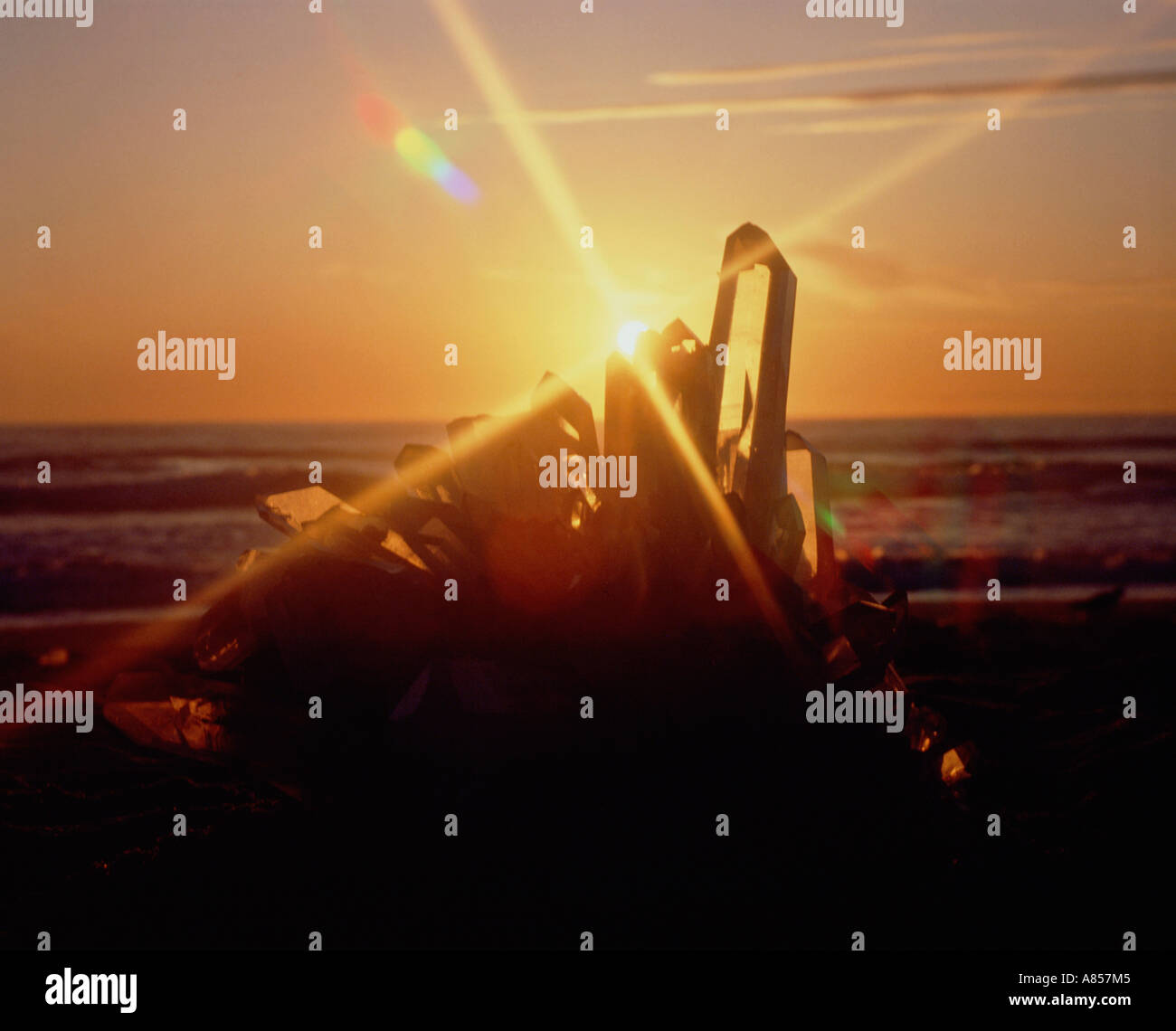 Mystical image of a Quartz Crystal structure on a beach with the sun shining through. Stock Photo