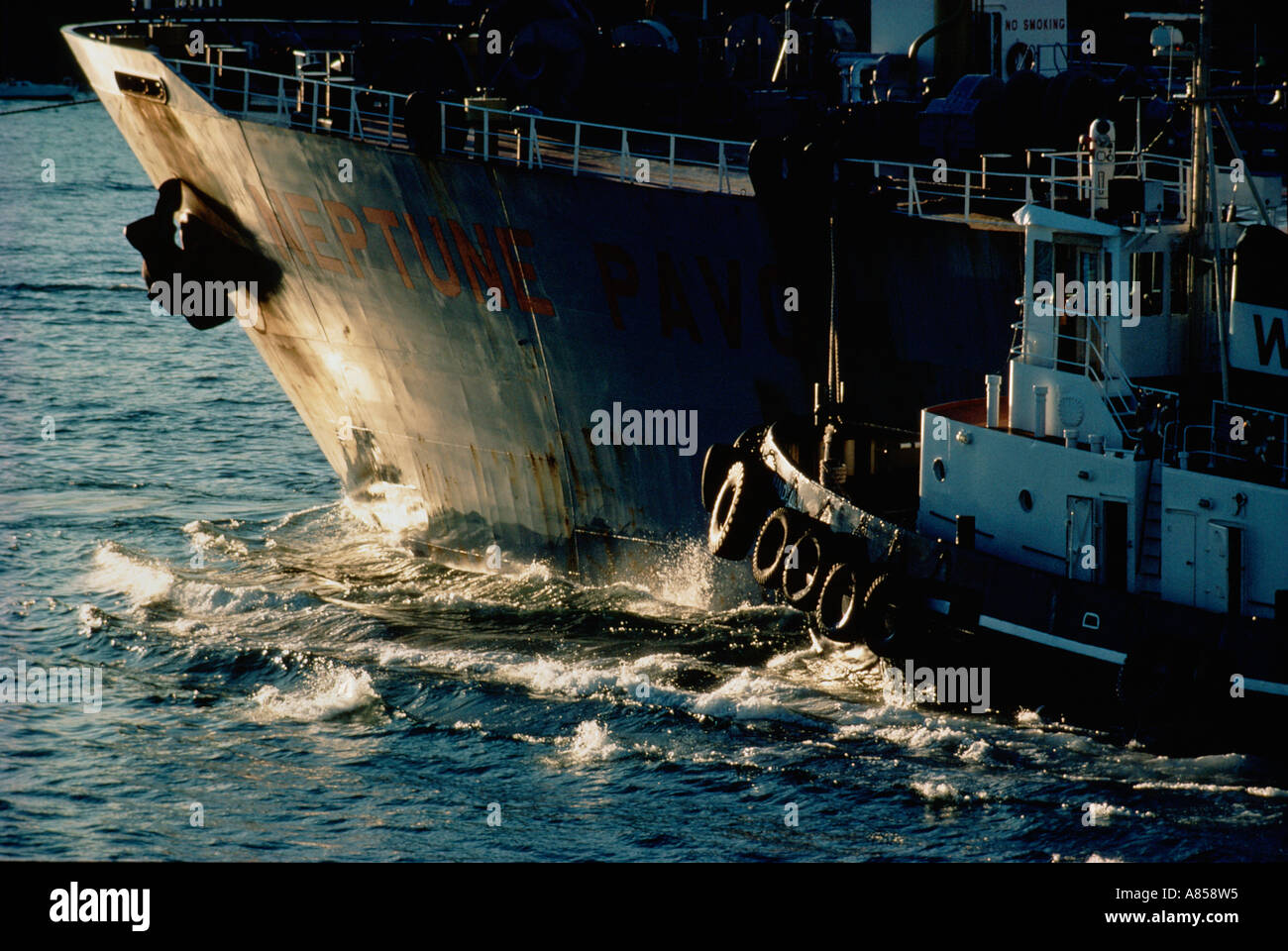 Ship being assisted by tugboat. Close-up of bow. Sydney harbour. Australia. Stock Photo
