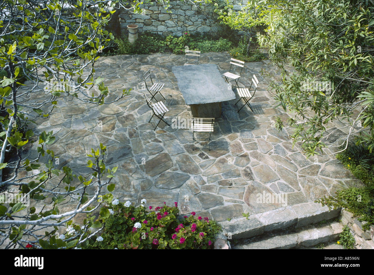 Terrace, chairs with slate table in garden in Ikaria, Greece (shot on Kodachrome 64) Stock Photo