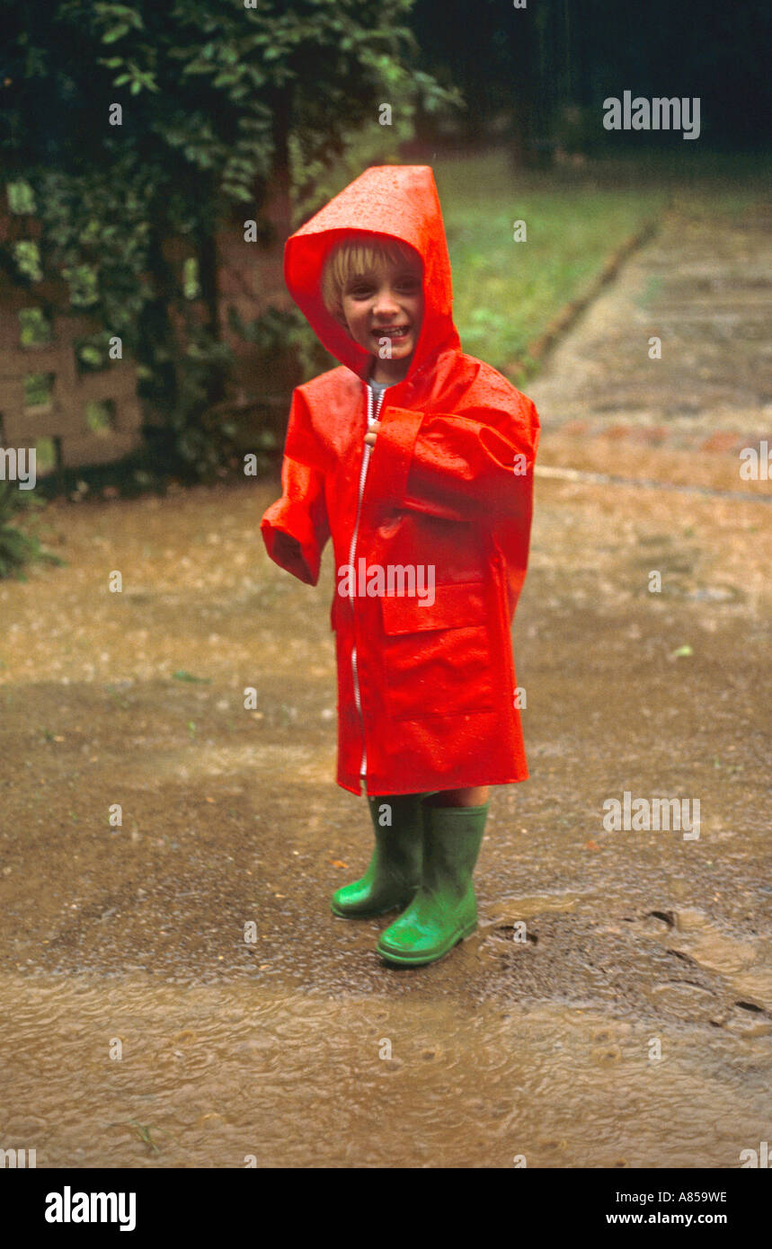 Red raincoat, green wellies. Stock Photo