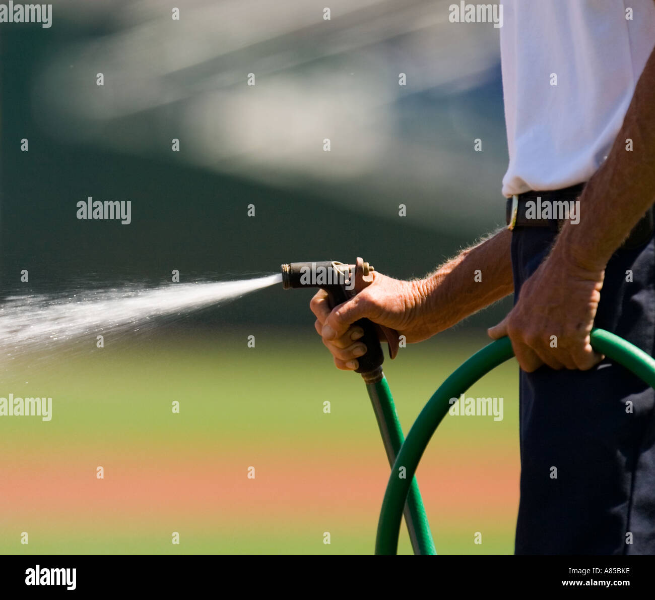 Man watering a lawn Stock Photo