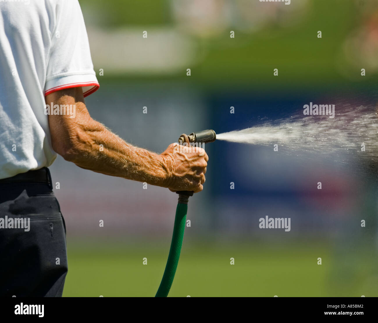 Man watering a lawn Stock Photo