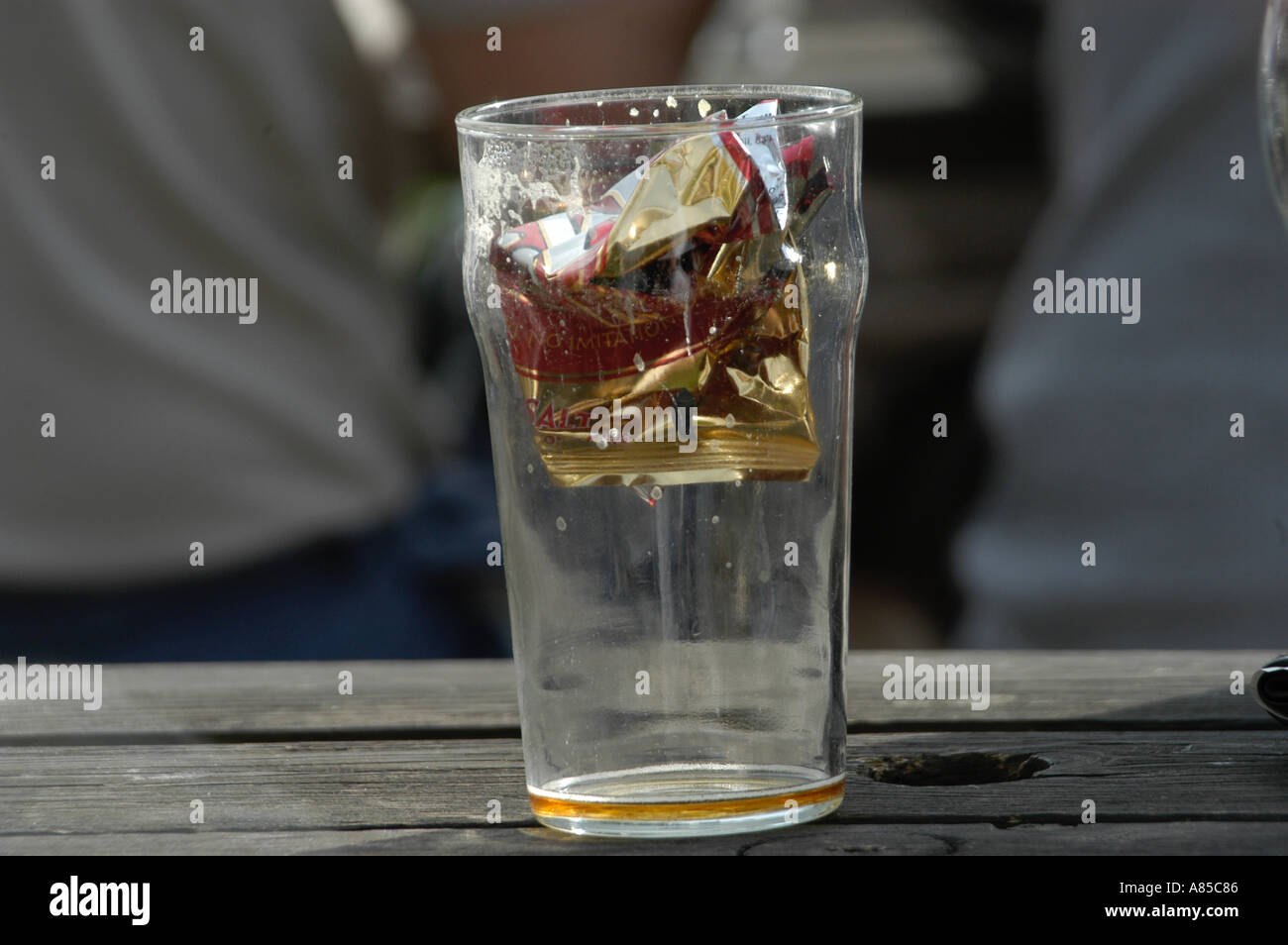 Pint Glass with Crisp Packet Stock Photo