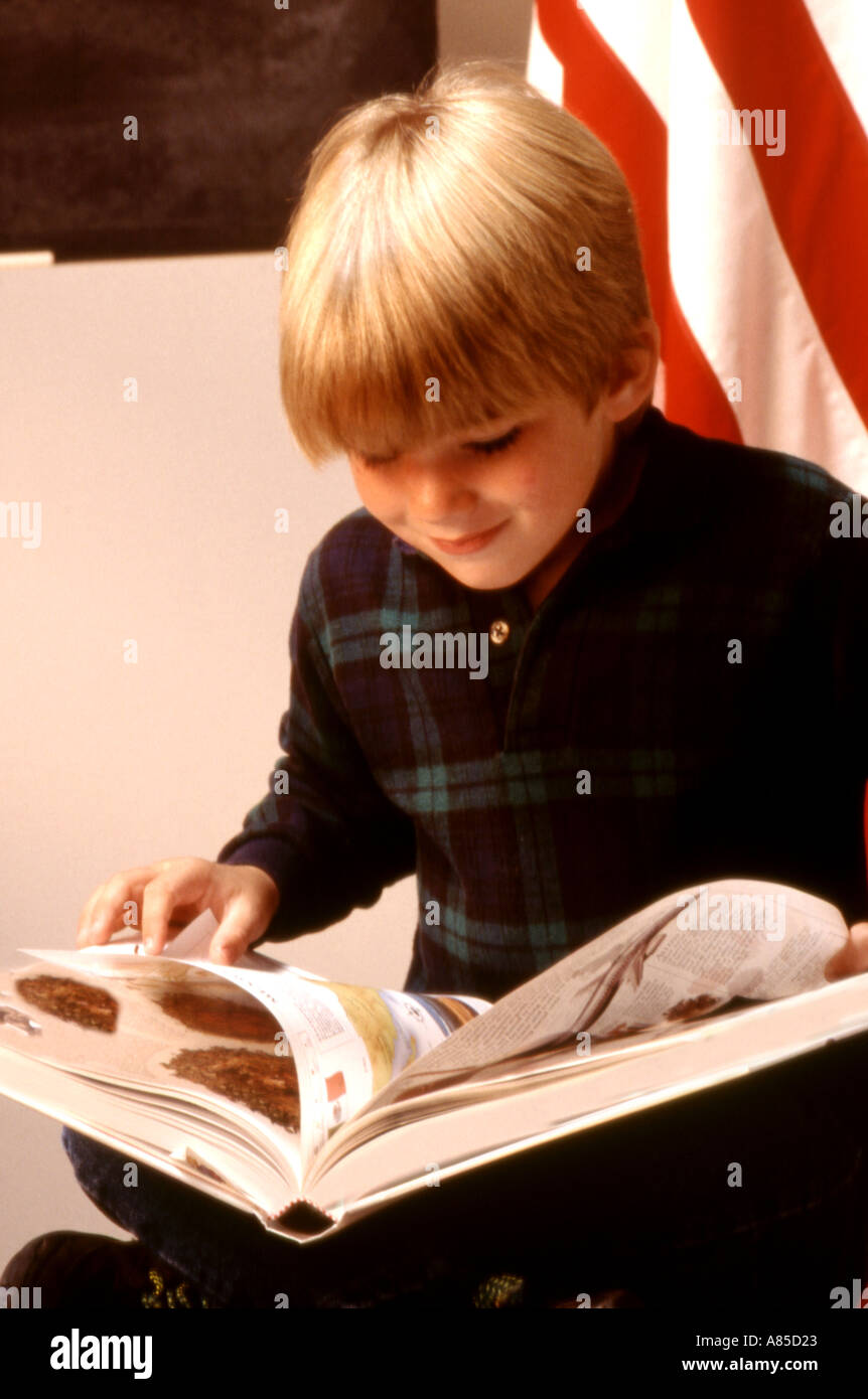 Elementary school student reading in classroom Stock Photo