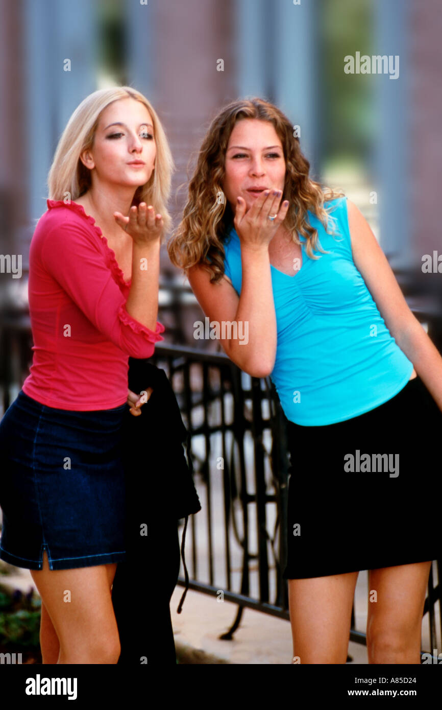 Teenage girls shopping and blowing kisses Stock Photo