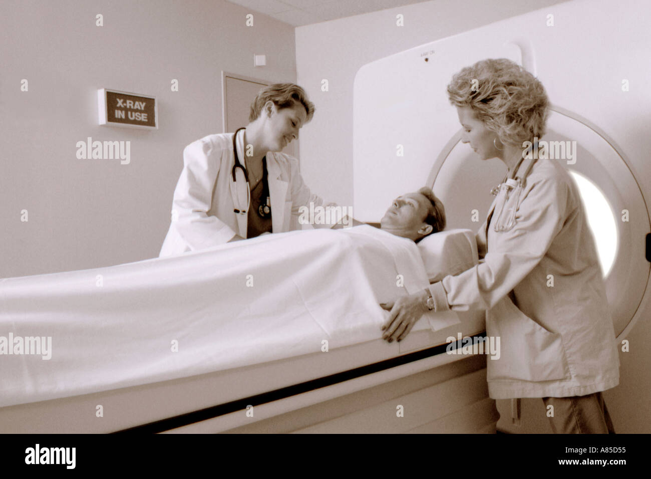 Nurses with patient in hospital performing a CAT scan Stock Photo