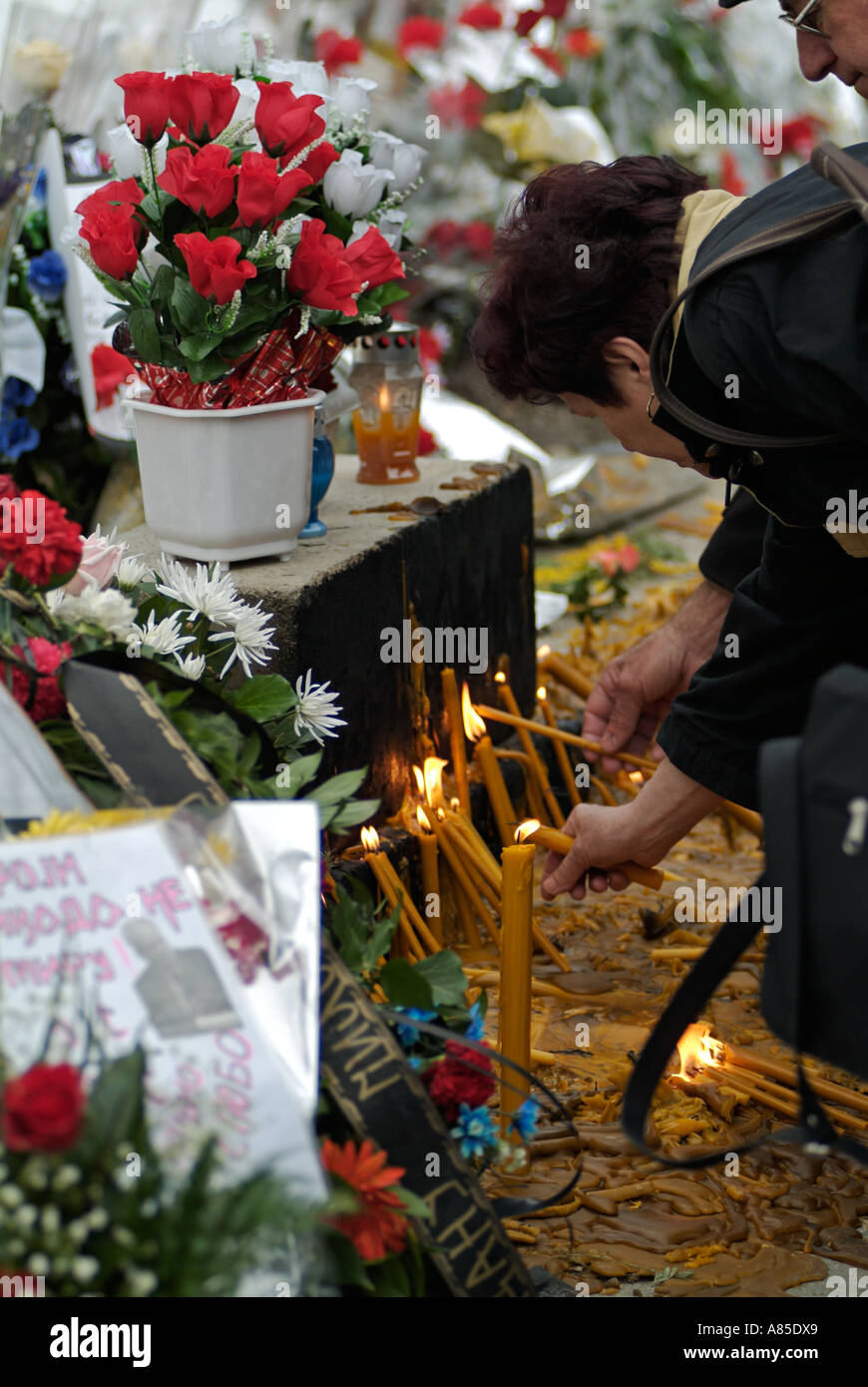 Bosnian Serb woman lights a candle at a memorial to Slobodan Milosevic in Banja Luka city centre Republika Srpska Bosnia Herzego Stock Photo